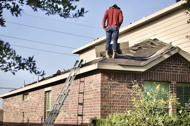 Professional roofer working on a residential roof in Bradbury Ranch